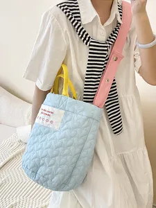 Quilted crossbody bag with heart pattern, cute tote shoulder bag with pink strap and yellow handles.