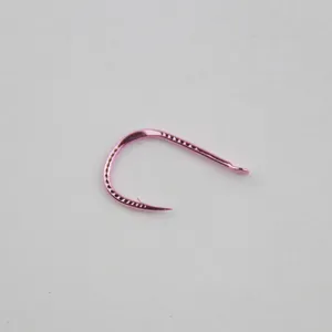 Pink fishing hook close-up, barbed metal design for freshwater angling, detailed view.