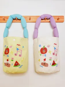 Cute canvas bucket bag with puffy handles and sweet cartoon prints, ideal for daily commute.