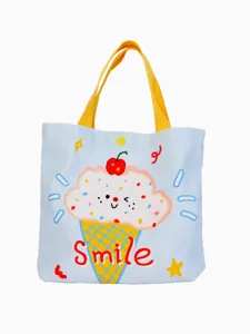 Cute cartoon ice cream print canvas tote bag with yellow handles, stylish casual bag.
