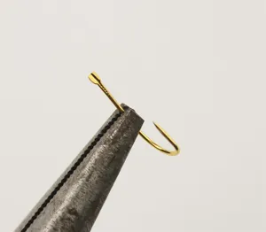 Gold barbless fishing hook detail view, thin wire sleeve hook with blood groove for carp.