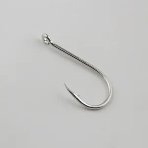 Close-up detail of a durable silver fishing hook with eyelet and barb for sea fishing.