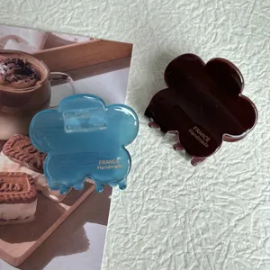 Detail view of resin flower hair claw in blue and brown, featuring smooth surface and cute floral shape.