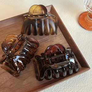 Details of hair claw clip, amber and brown tortoise shell design, strong spring for thick hair.