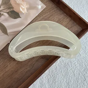 Clear resin curved hair claw clip detail, elegant jelly style hairpin for women styling.