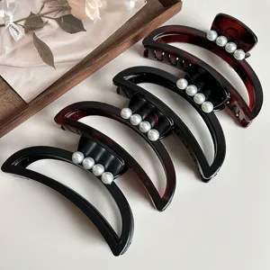 Minimalist crescent hair claw clips with faux pearls, elegant black and tortoiseshell design.