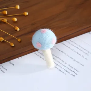 Blue wool felt mushroom DIY accessory detail view, cute craft material for handmade hair clips.