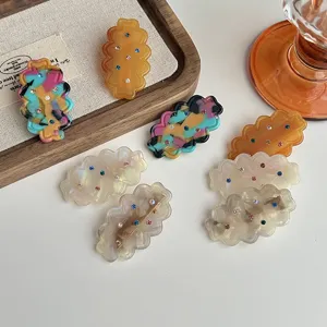 Detailed shot of Korean sweet resin hair clips featuring wavy shapes and colorful rhinestones.