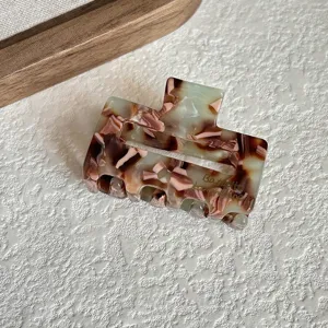 Small acetate hair claw clip featuring trendy green and brown marble pattern for elegant daily wear.