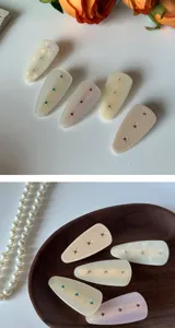 Closeup detail of French vintage acetate hair clips featuring colorful rhinestones for daily wear.