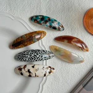Detailed view of French vintage acetate oval hair clips featuring exquisite tortoiseshell patterns.