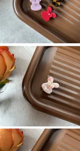 Detailed view of sweet butterfly acetate hair claw, small size minimalist hair accessory.