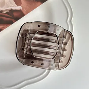 Detailed view of the vintage brown translucent hair claw clip with strong metal spring.