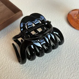 Black glossy hair claw clip for women, large shark clip for thick hair styling and elegant updos.