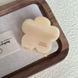 Detailed view of the cream flower hair claw clip, elegant design for secure and stylish updos.