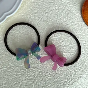 Detail view of cute acetate bow hair ties, elegant translucent gradient hair loops for women.