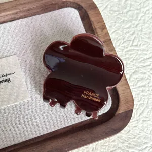 Brown flower hair claw clip, glossy resin medium hair catch, elegant daily hair styling accessory.