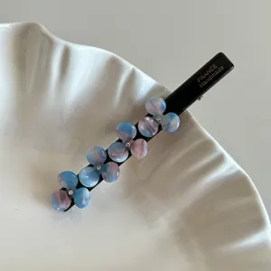 Exquisite floral cellulose acetate duckbill hair clip detail, elegant side hairpin accessory.
