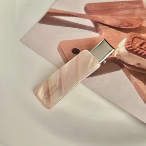 Pink acetate hair clip detail shot, marble texture side barrette for women and girls styling.