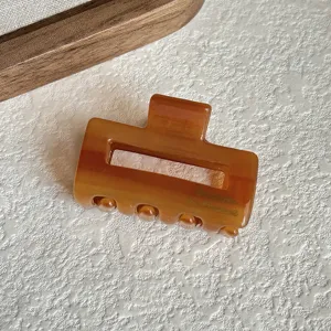 Amber acetate hair claw clip close-up shot, stylish mini geometric hair accessory detail view