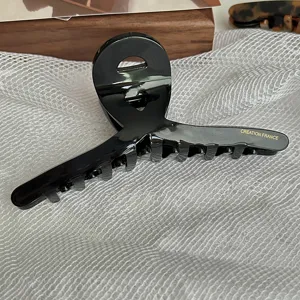 Large black acetate hair claw clip with hollow design, elegant French hair accessory for women.
