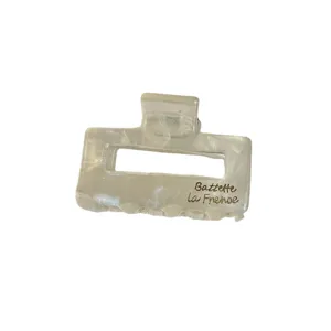 Small acetate hair claw clip, rectangular hollow design, elegant pearlescent white style.
