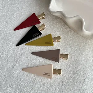Detailed shot of trendy triangle hair clips in multi-colors, showcasing sleek duckbill design.