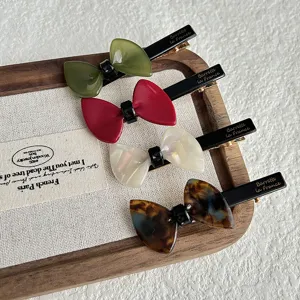 Set of 4 elegant bow hair clips with resin bows and duckbill design for women and girls.