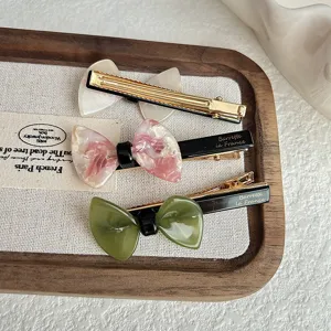 Korean sweet bow hair clips for women, cute acrylic side hair barrettes for daily styling.