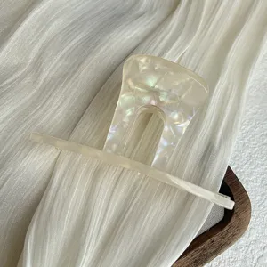 Pearl acetate hair claw clip detail shot, elegant U-shaped hair accessories for women styling.
