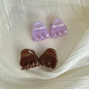 Detailed view of cute mini acetate hair claw clips in purple and brown, perfect for fringe.