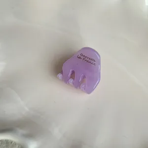 Mini purple acetate hair claw clip detail shot, cute small hair accessory for styling side bangs.