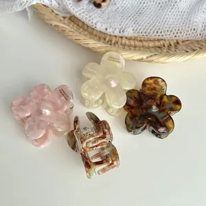 Detailed close-up view of elegant flower hair claws featuring translucent marble color patterns.