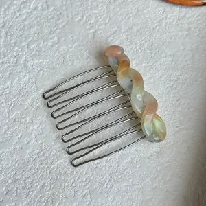 Close-up detail of the French style gradient resin hair comb with metallic teeth for chic styling.