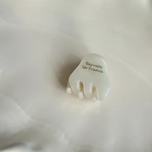 Mini white hair claw clip detail, cute translucent acetate hair accessory for styling.