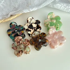 Resin floral hair claw clip with colorful marbled design, perfect for elegant half up dos.