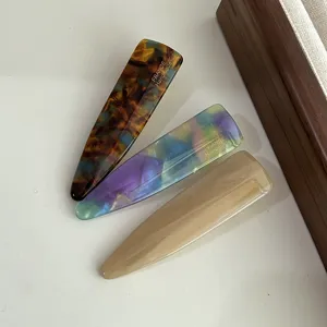 Detail shot of stylish acetate hair clips set featuring tortoise and color finish.
