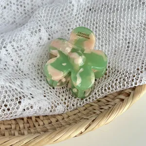Green and pink marbled floral hair claw clip, stylish acrylic shark clip for women styling.