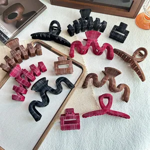 Detailed view of trendy plaid velvet hair claws, stylish autumn and winter hair accessories.