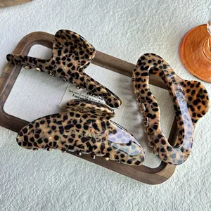 Detailed close-up view of chic leopard print hair claw clips, showcasing premium texture and design.