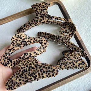 Detailed view of trendy leopard print hair claw clips in various shapes, premium acetate material.