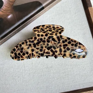Chic leopard print hair claw clip, elegant French handmade acetate shark clip for women styling.
