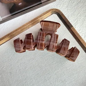 Brown plaid velvet hair claw clip detail, stylish headwear for women ponytail and hair bun.