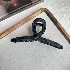 Korean style plaid velvet hair claw clip for women, elegant hollow shark clip for hair styling.