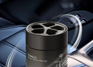 Detail shot of solid car air freshener featuring honeycomb vent and sleek black design.