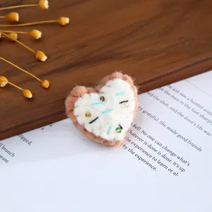 Handmade wool felt heart shaped DIY accessory for hair clips, hats and crafts decoration.