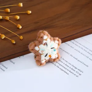 Handmade wool felt star cookie hair accessory DIY craft material for cute decorative accents.