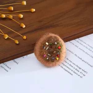 Handmade wool felt round craft accessory with colorful beads detail for DIY hat decor.