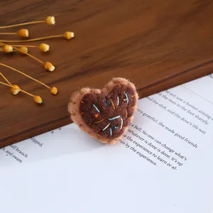 Handmade wool felt heart patch detail, perfect for DIY hair clips, hats, and garment decoration.