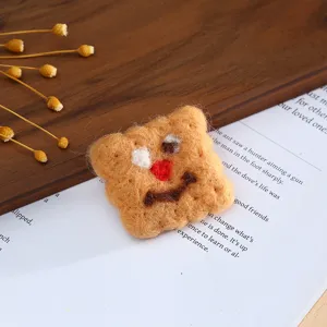 Handmade wool felt cartoon bear cookie shape DIY craft accessory nice detail close up view.